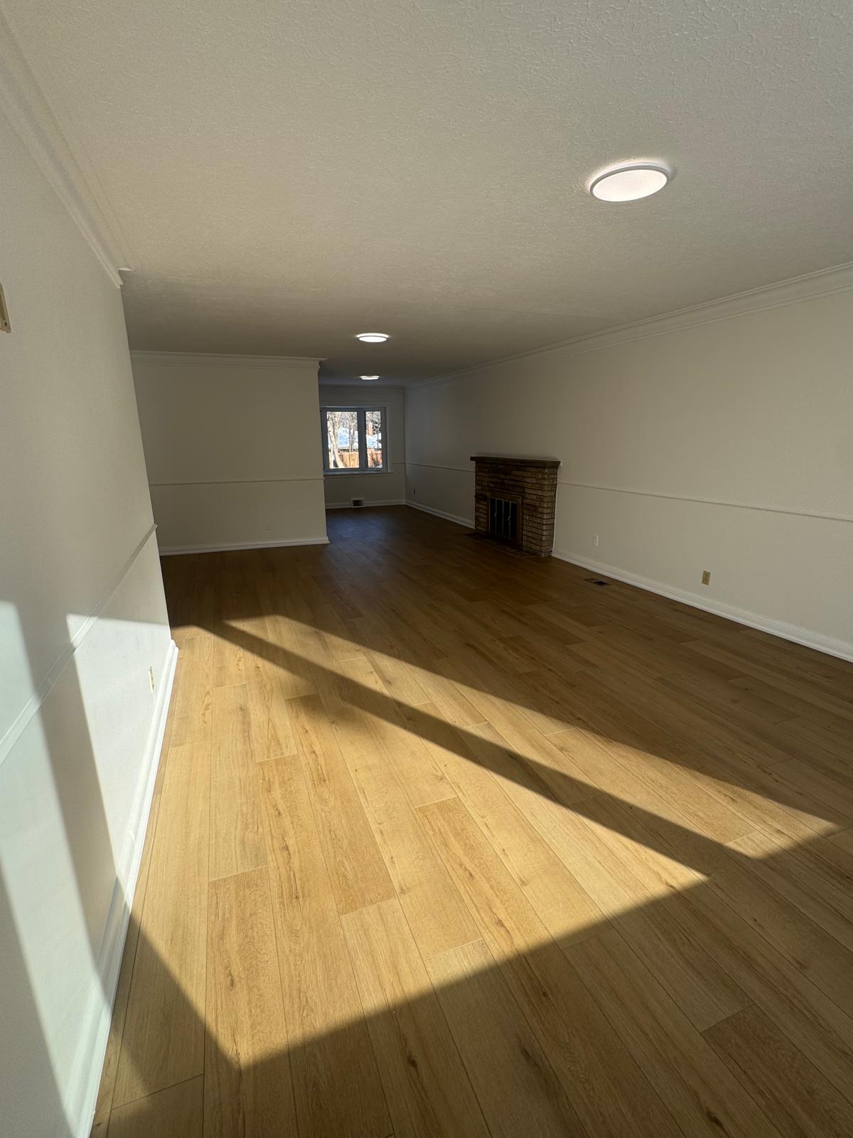 Hardwood flooring on open concept main floor with fireplace