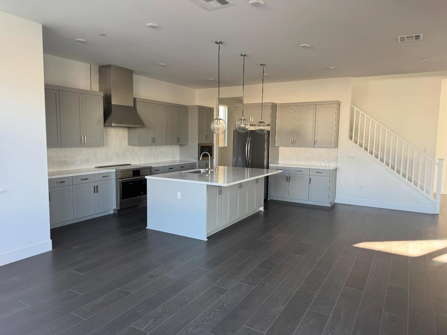Clean finished basement bedroom with natural oak LVP and white walls